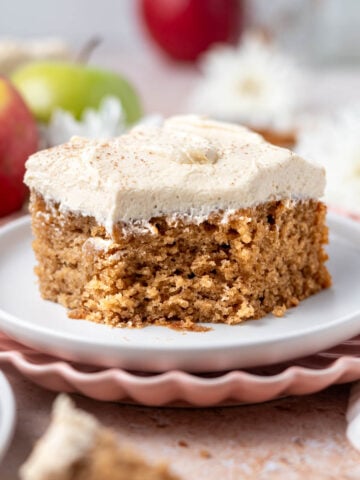 slice of apple snack cake with brown sugar frosting on a plate