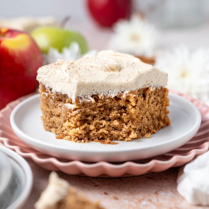 slice of apple snack cake with brown sugar frosting on a plate