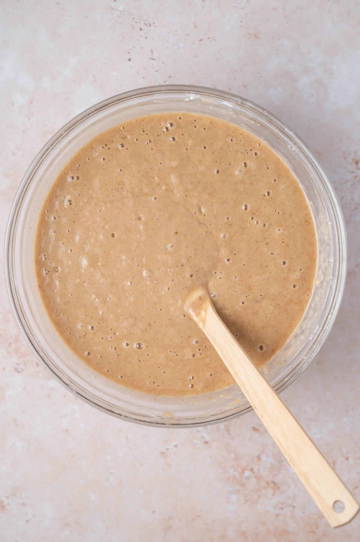 apple snack cake batter in a mixing bowl with a spatula