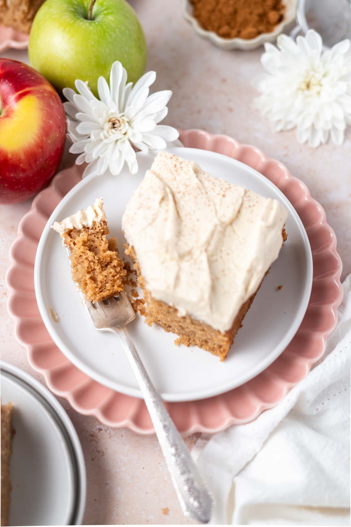 slice of cake on a plate with a bite on a fork