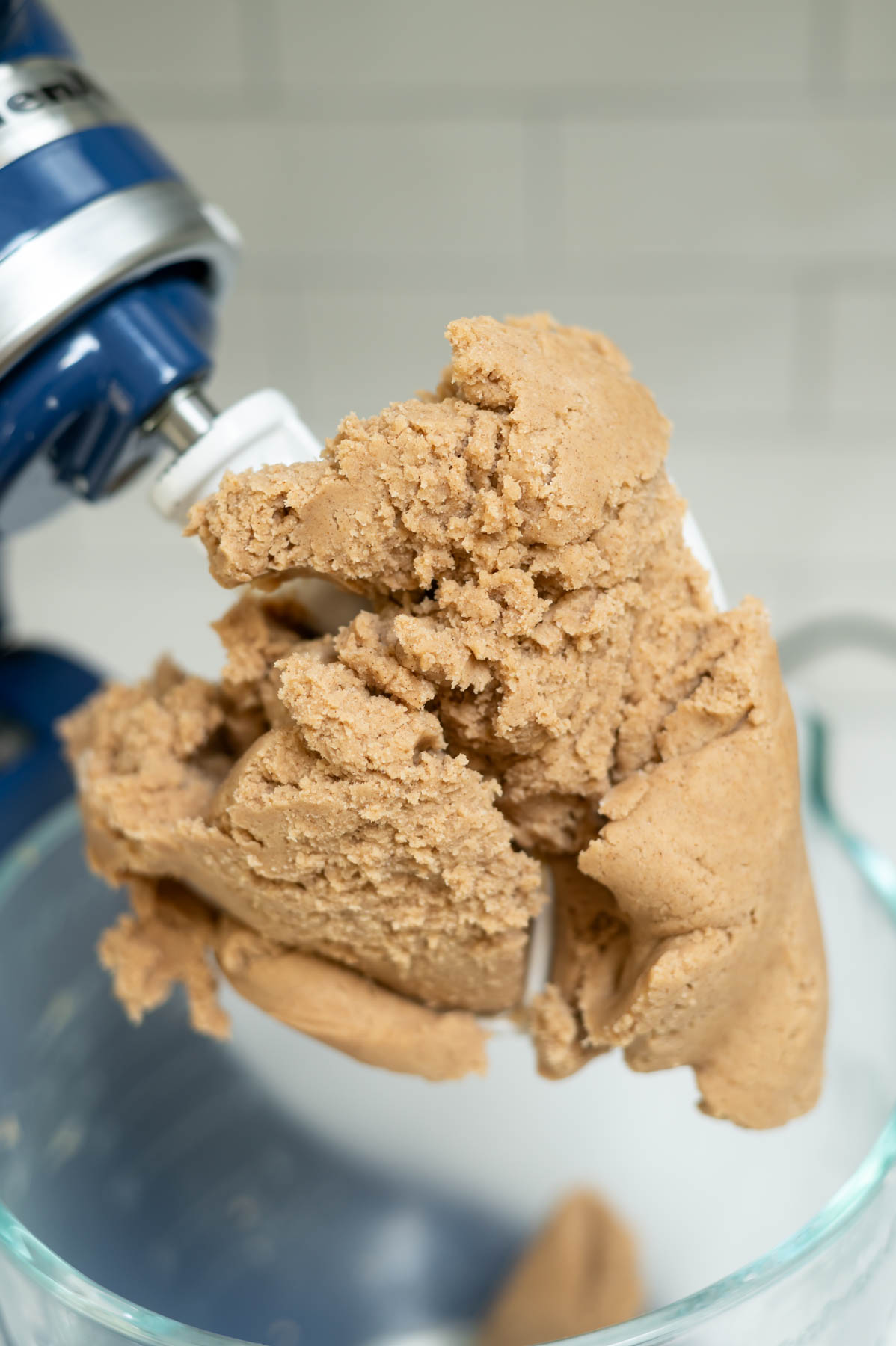cookie dough clinging to paddle on the mixer
