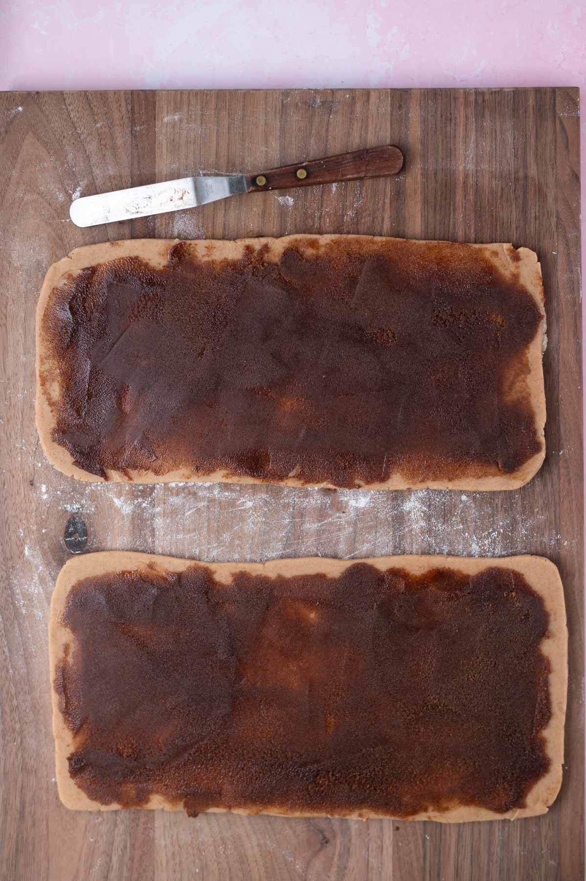 cinnamon roll filling spread over cookie dough