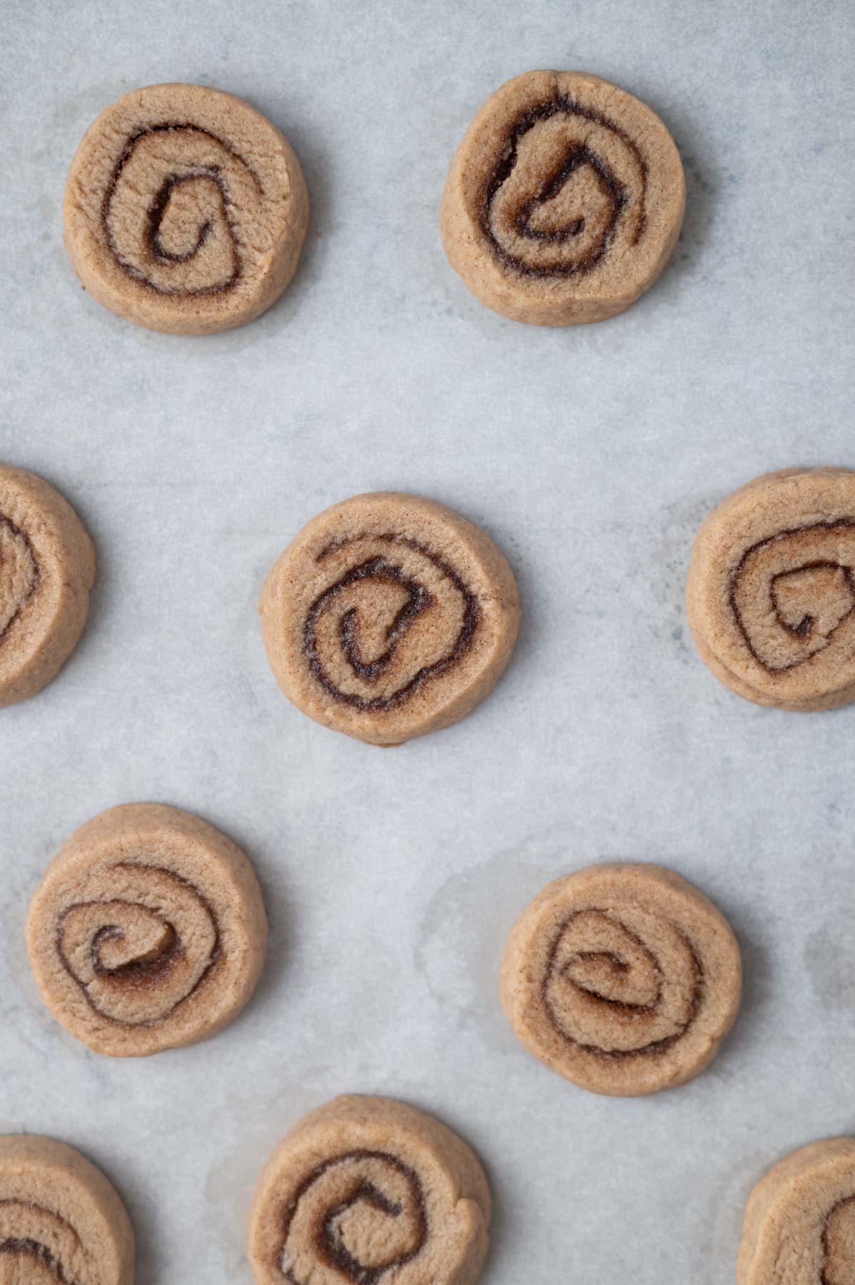 unbaked cookies on a parchment lined baking sheet