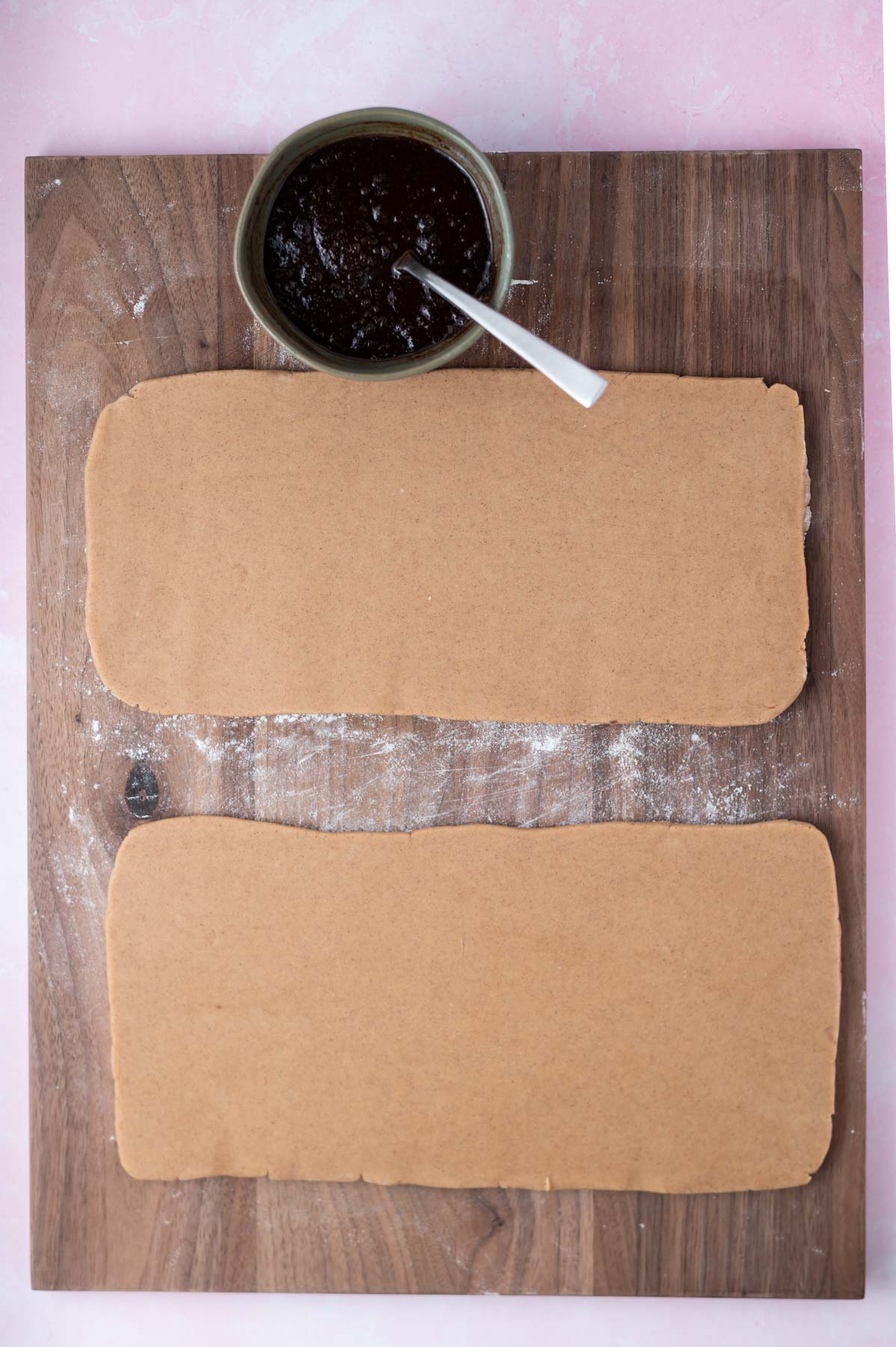 two pieces of rolled out dough on a cutting board
