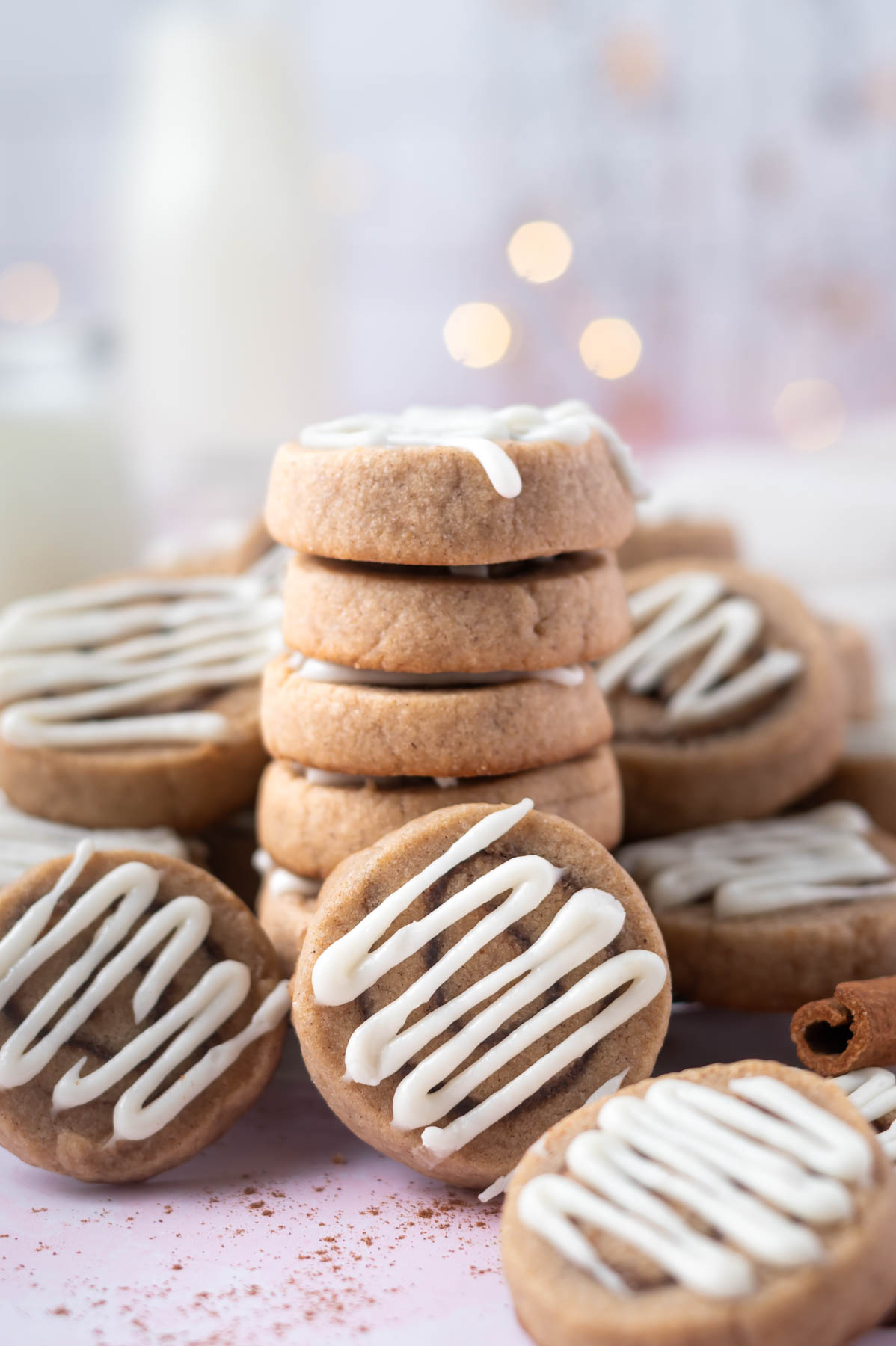 stack of cookies with milk in the background