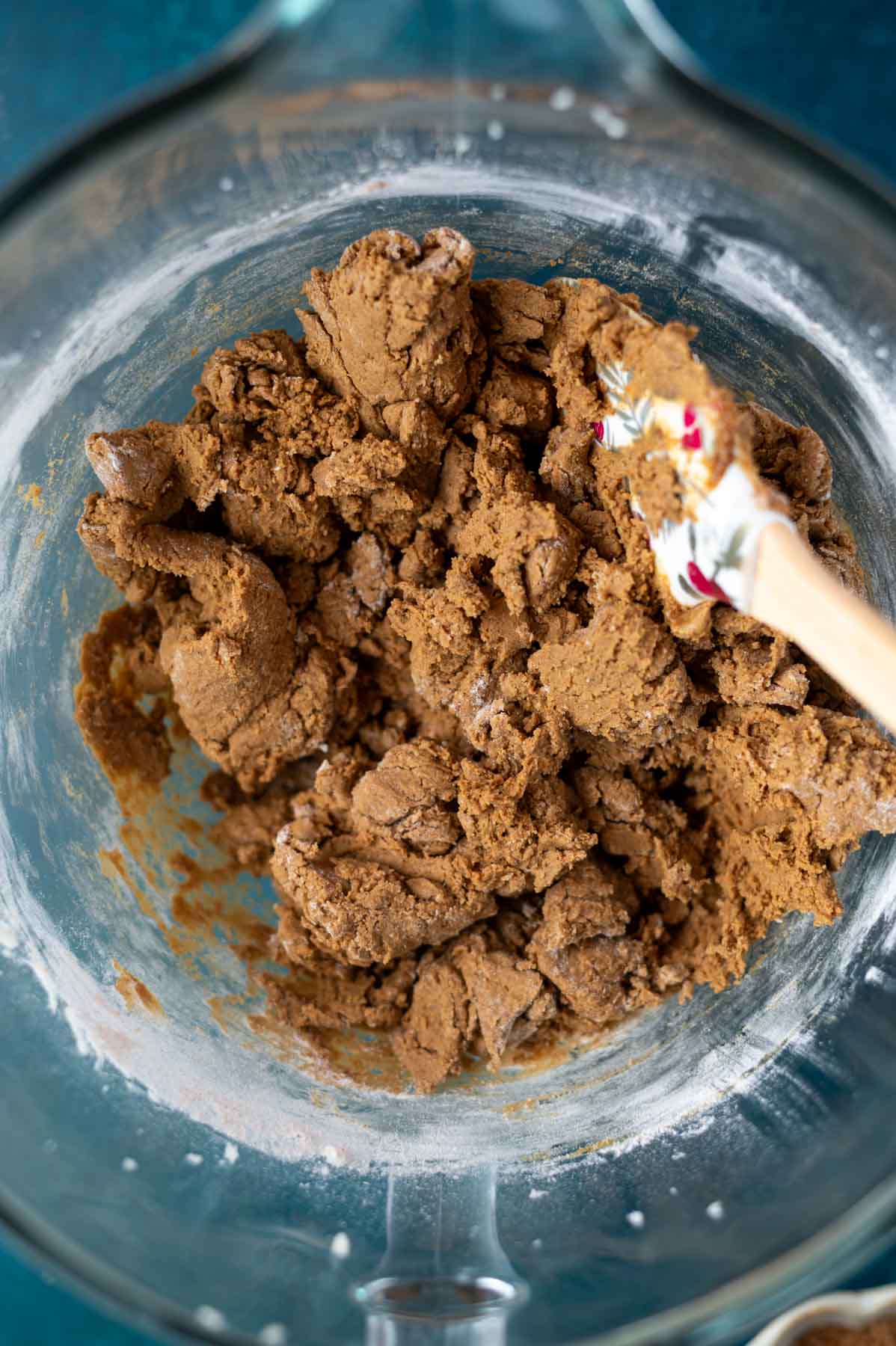 gingerbread cookie dough in a mixing bowl with a spatula