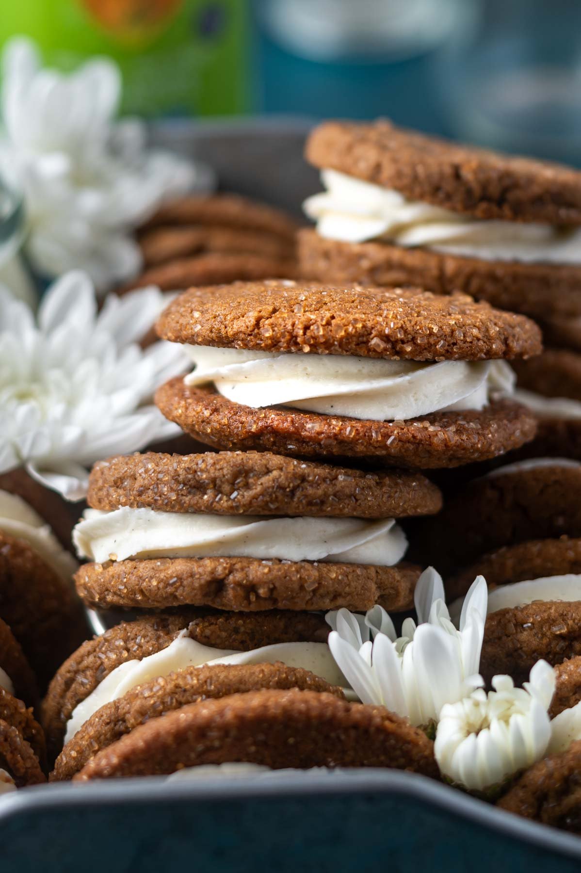 gingerbread sandwich cookies in a serving tray with fresh flowers