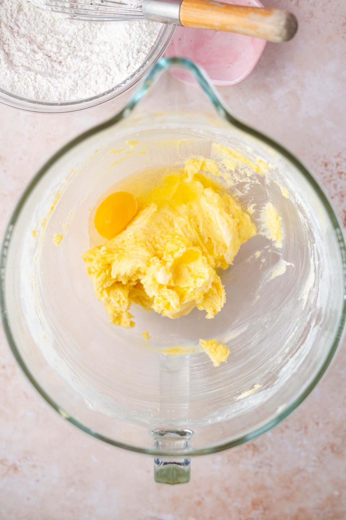 butter and sugars scraped from a mixing bowl and an egg added to the dough