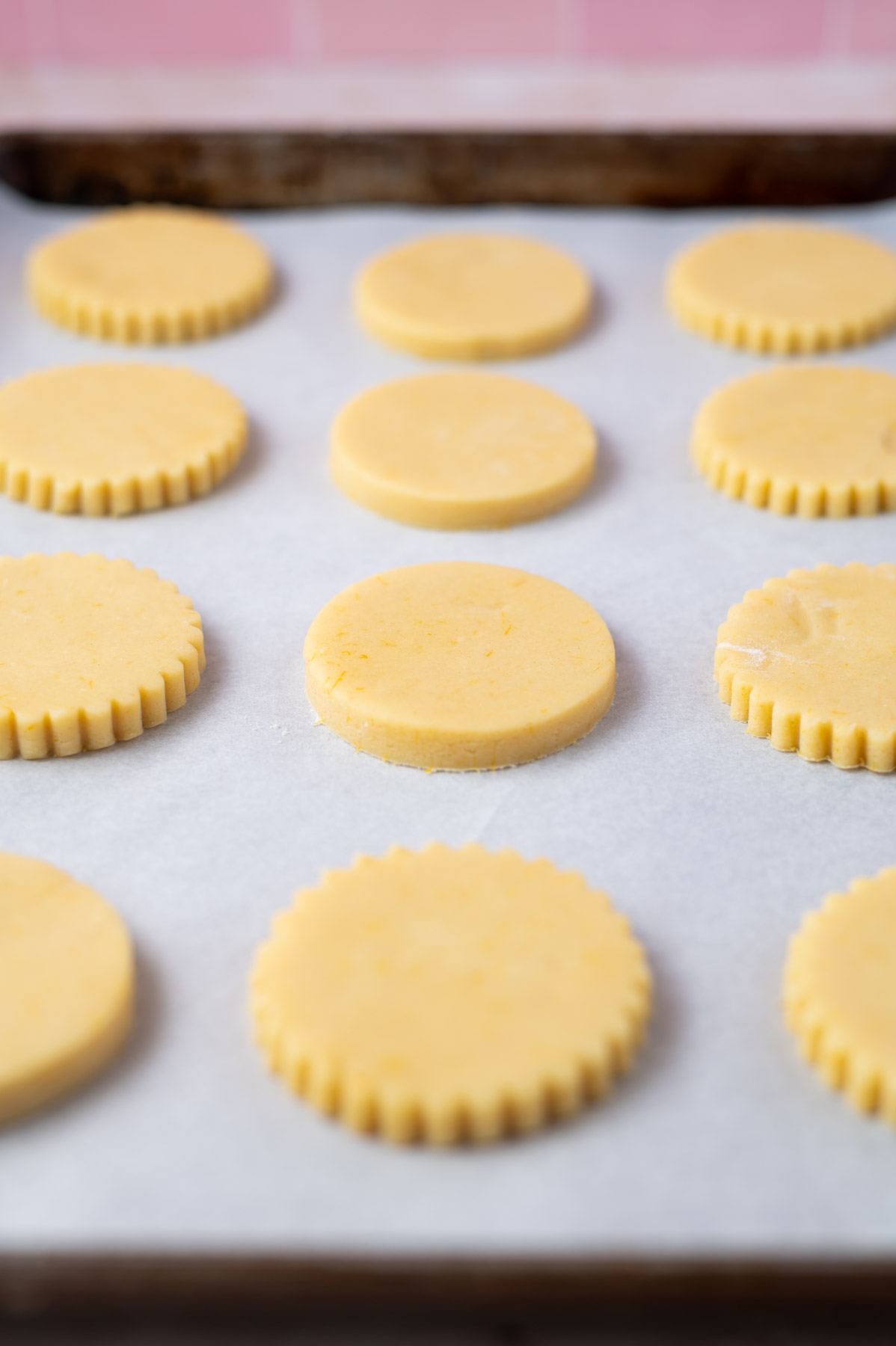 cookie dough cut outs on a parchment lined baking sheet