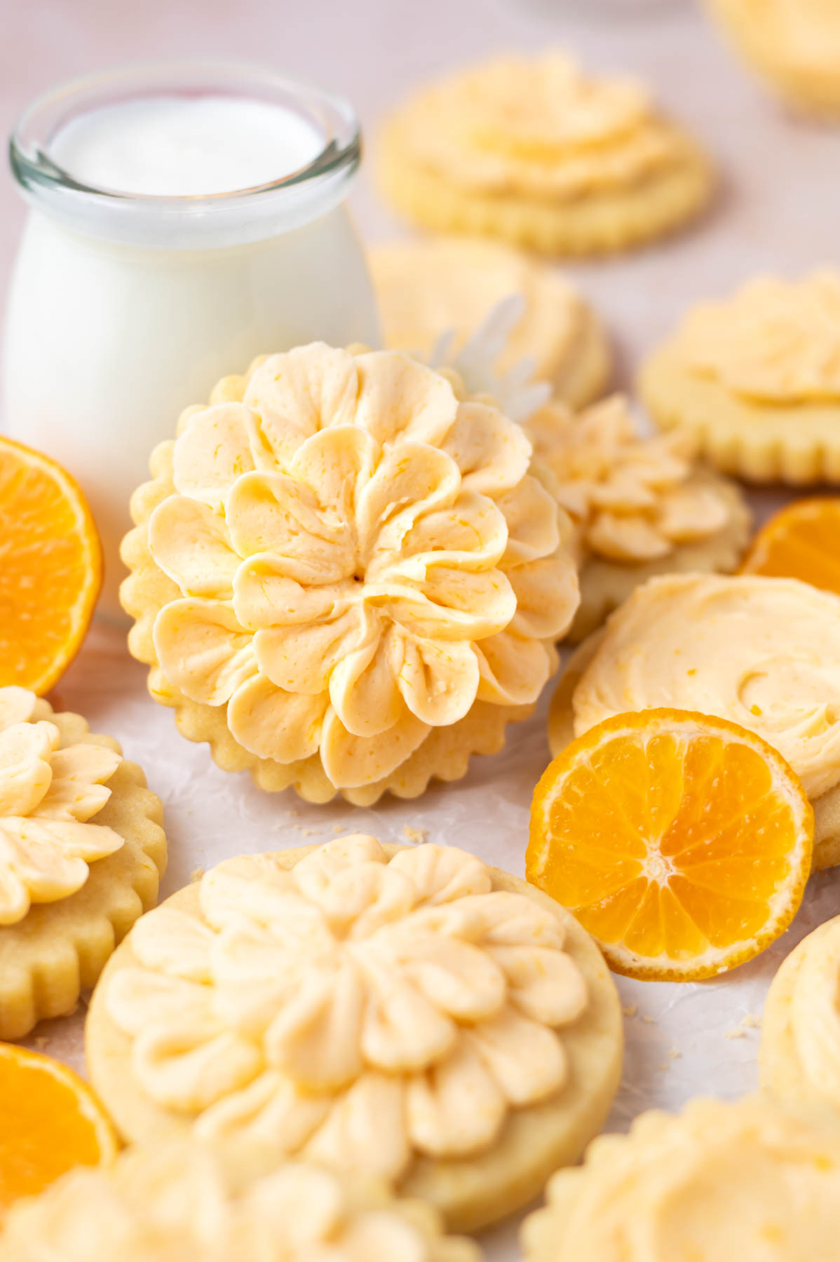 decorated cookies up against a glass of milk