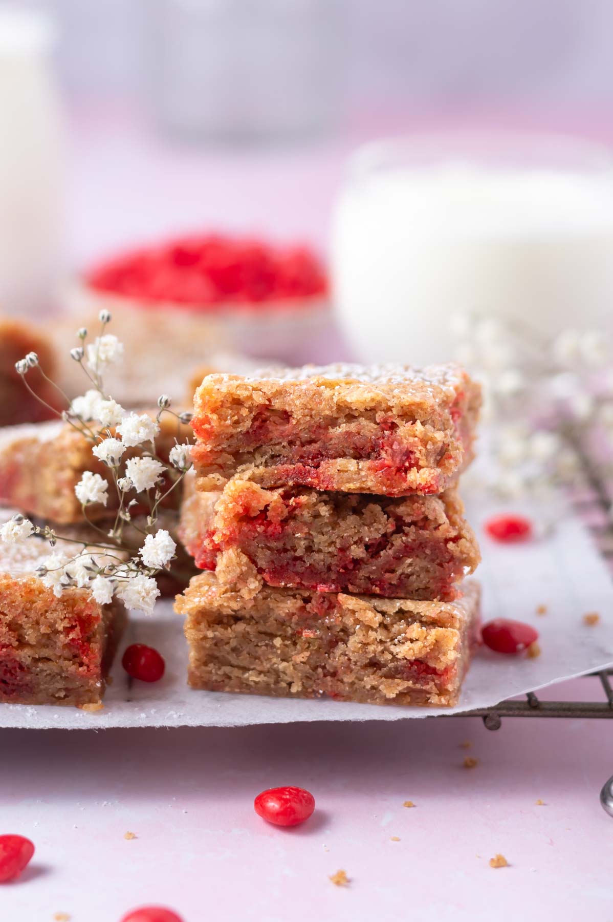stack of cookie bars on a cooling rack with milk in the background