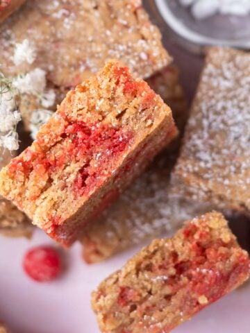 cinnamon blondies with one on its side showing cinnamon candy filled soft center