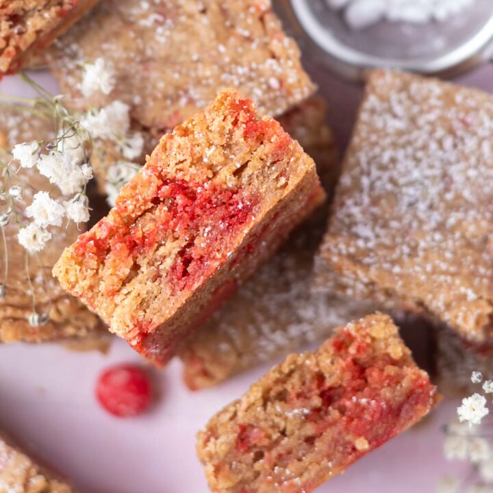 cinnamon blondies with one on its side showing cinnamon candy filled soft center