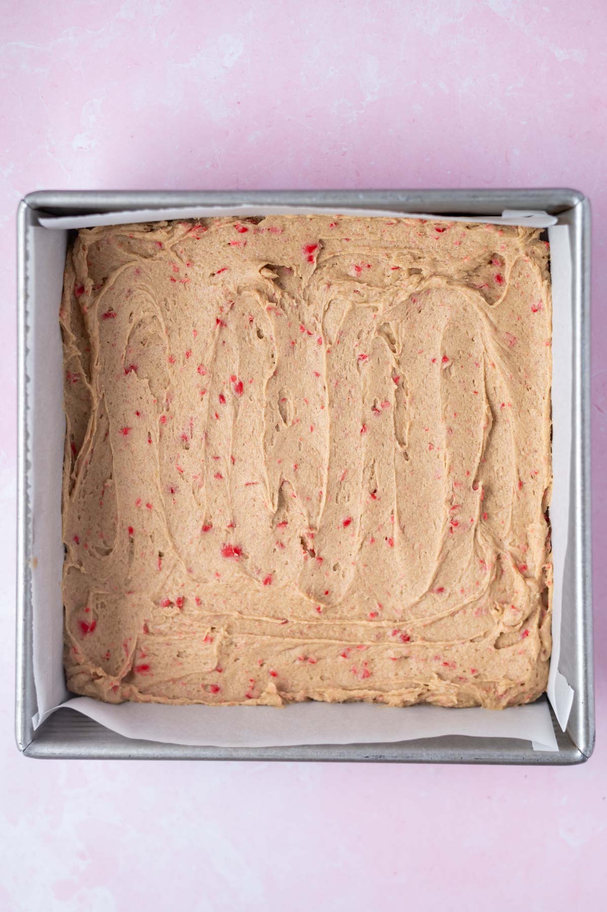 blondie batter in a parchment lined baking pan