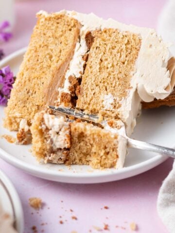 slice of cookie butter cake on a plate with a fork