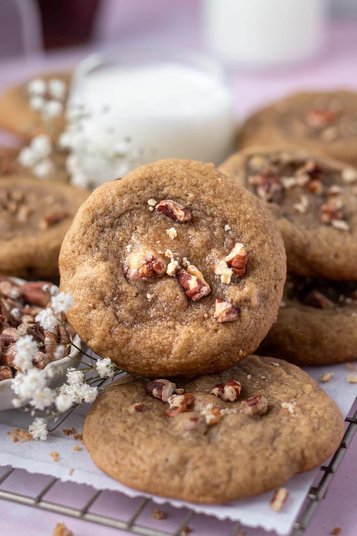 maple pecan cookie with a glass of milk in the background