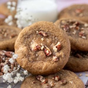 maple pecan cookie with a glass of milk in the background