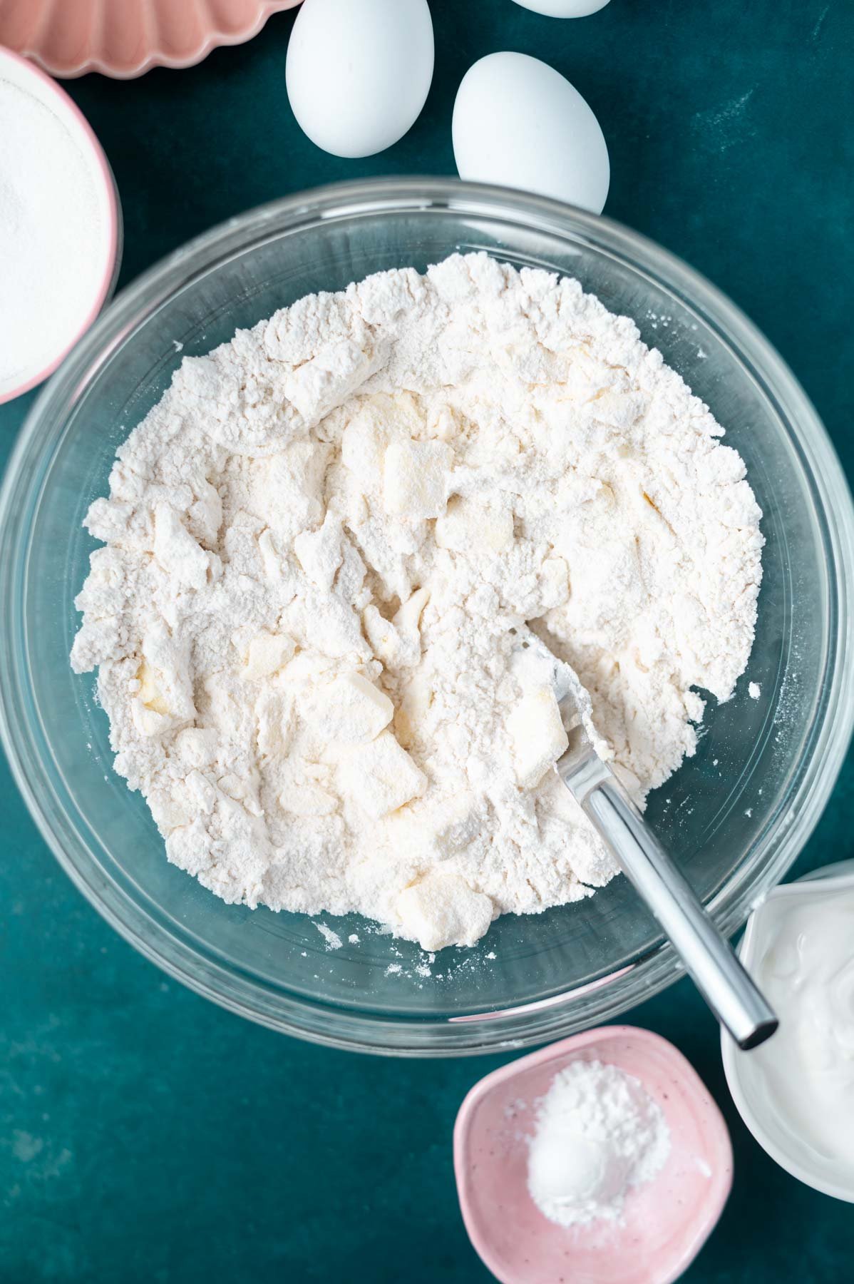 flour, sugar and butter in a glass bowl with a fork