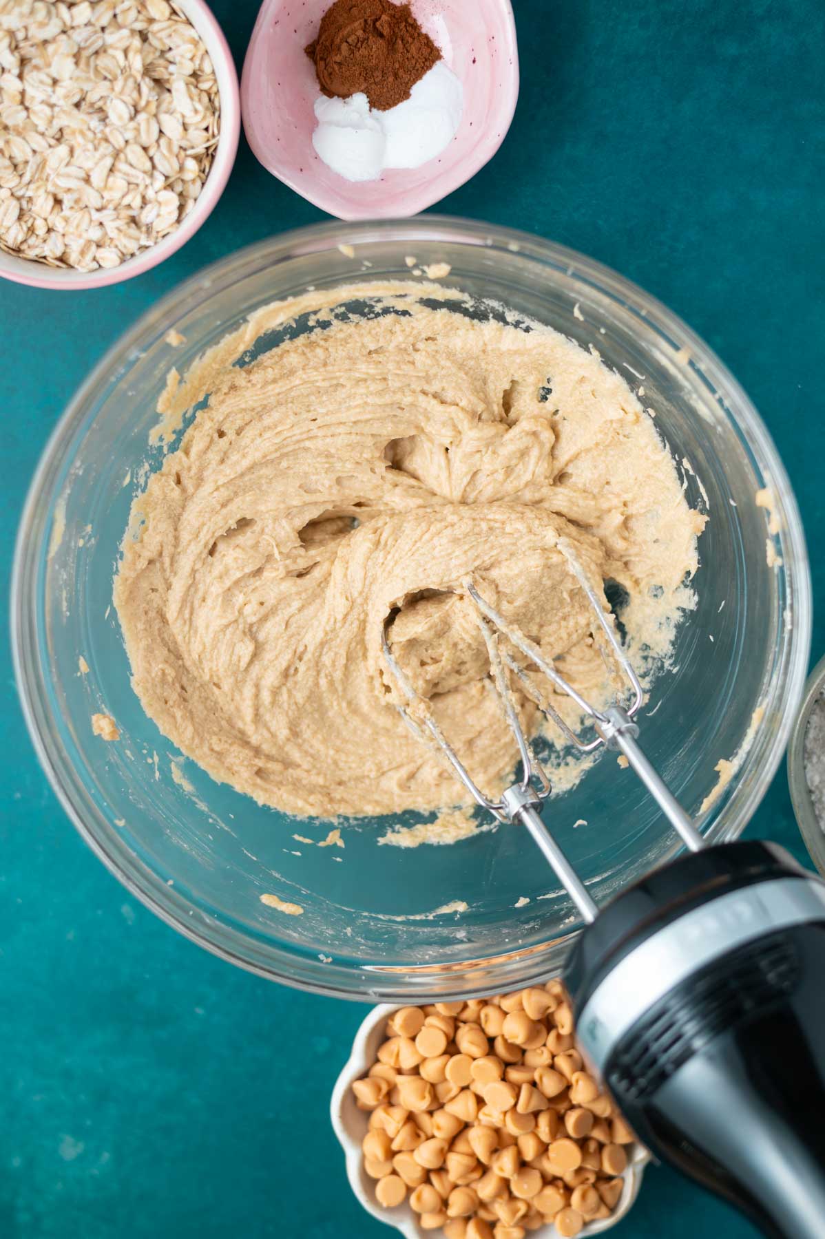 eggs added to cookie bar dough in a bowl with a handmixer