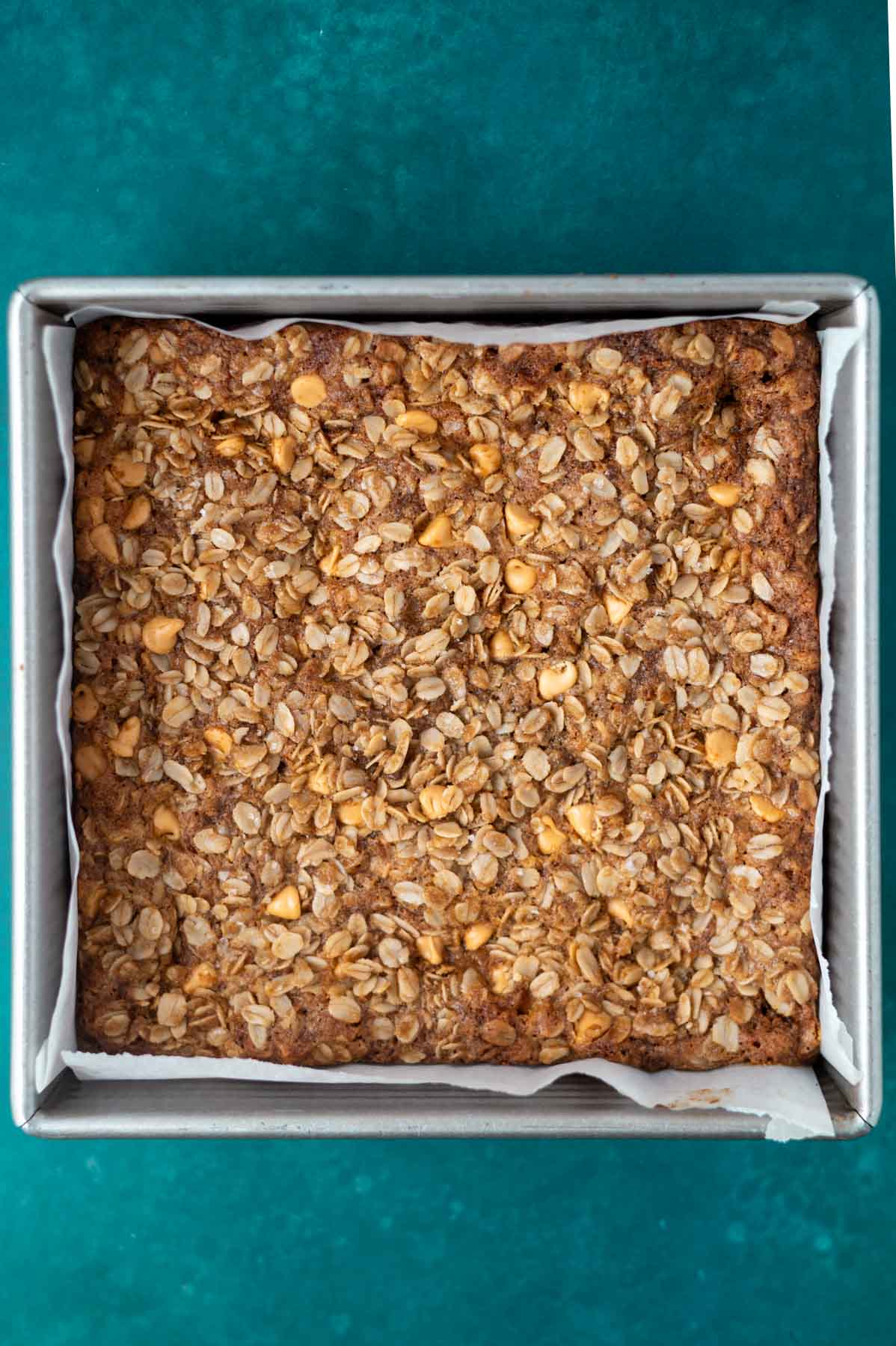 baked butterscotch oatmeal bars in a parchment lined baking pan