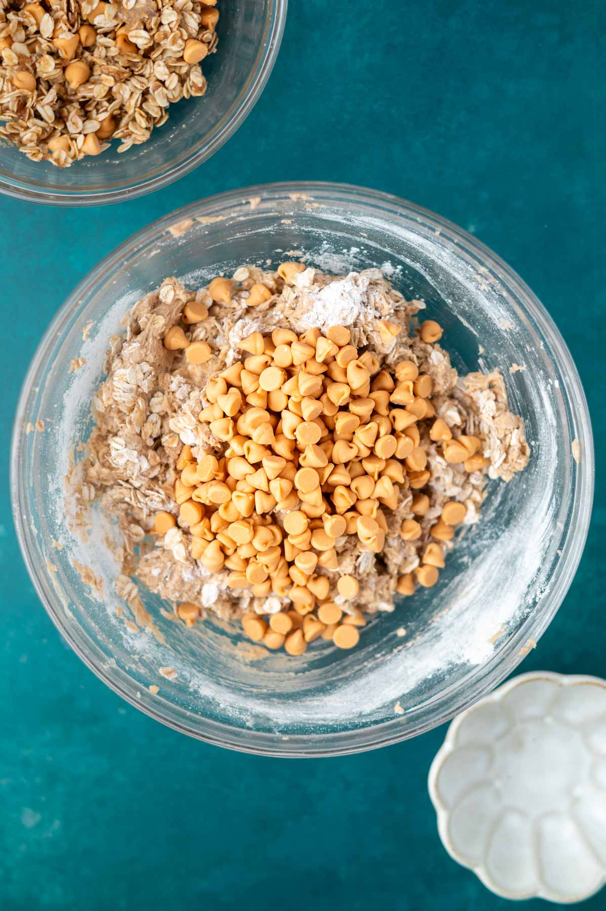 butterscotch chips on top of cookie bar batter in a bowl