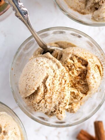 overhead look at cinnamon ice cream in a bowl with a spoon