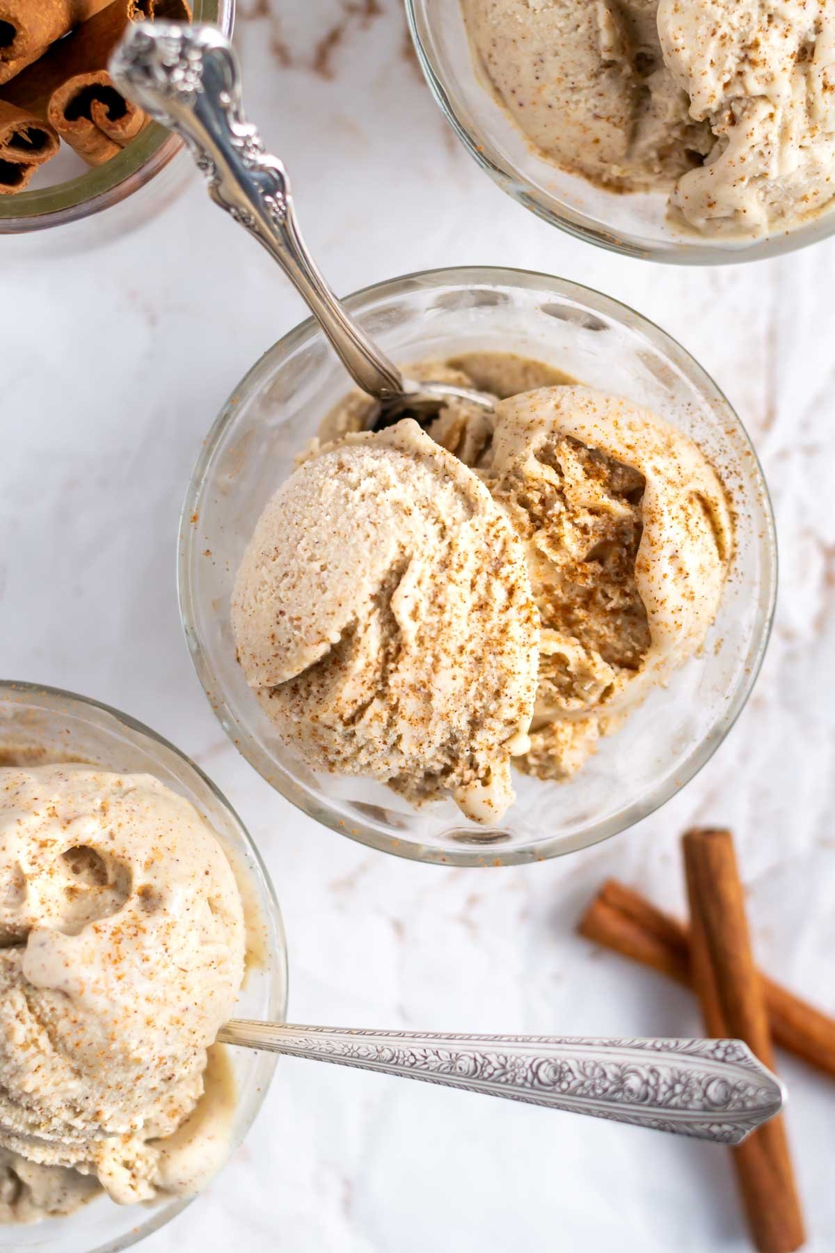 overhead look at cinnamon ice cream in a bowl with a spoon
