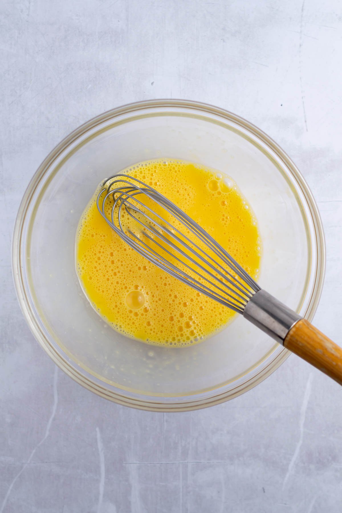 whisked eggs in a glass bowl