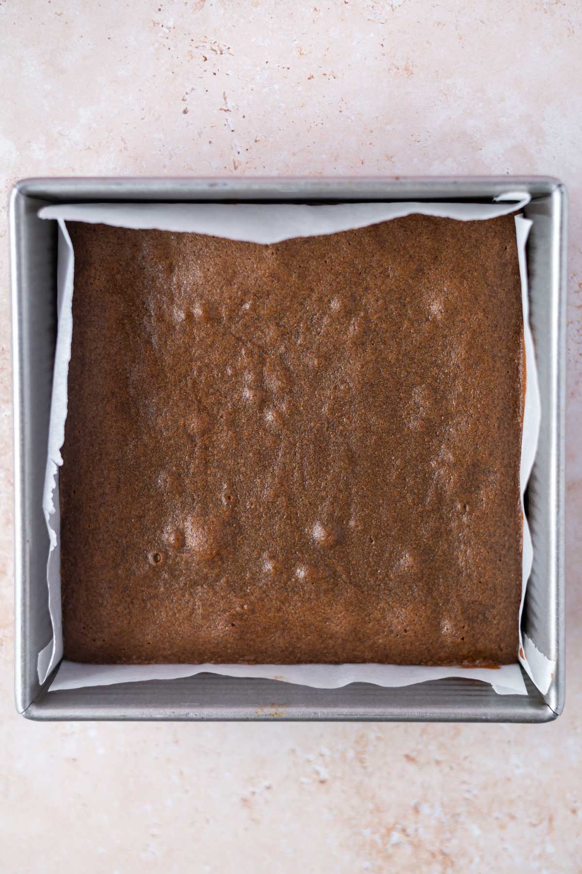 baked blondies in a parchment lined baking pan