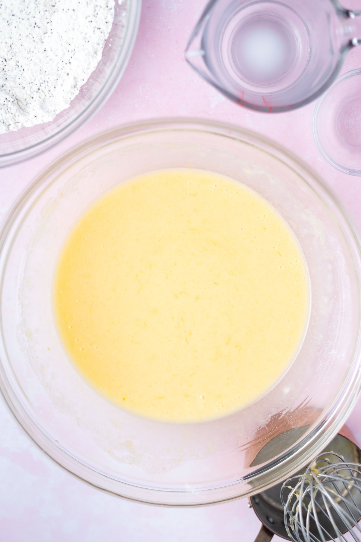 milk added to wet cupcake ingredients in a bowl