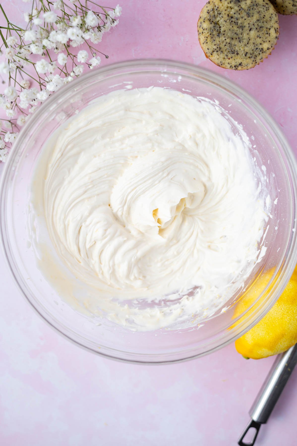 whipped lemon mascarpone frosting in a bowl after whipped cream and lemon zest have been added