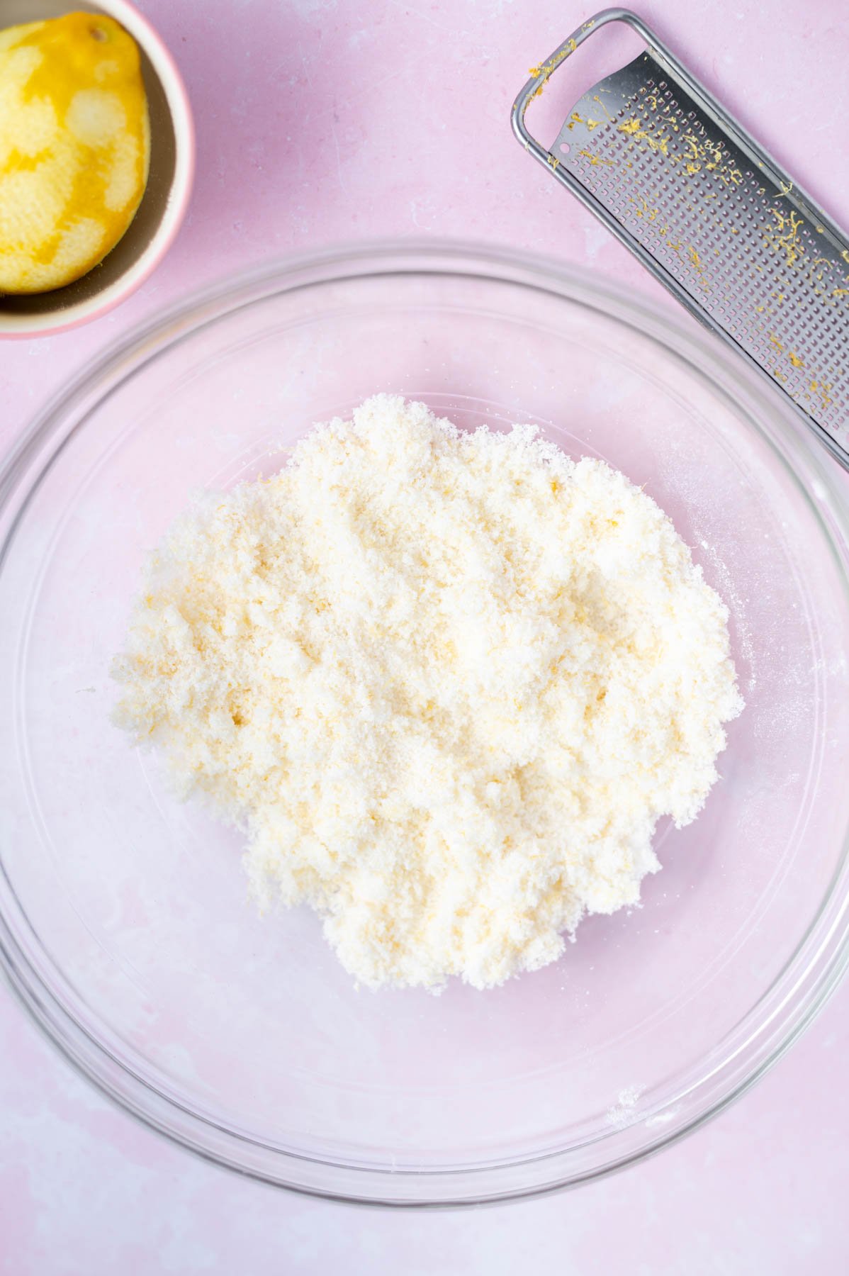 lemon zest worked into sugar in a glass bowl