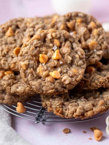 pile of oatmeal butterscotch cookies on a cooling rack