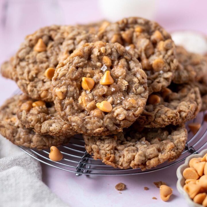 pile of oatmeal butterscotch cookies on a cooling rack
