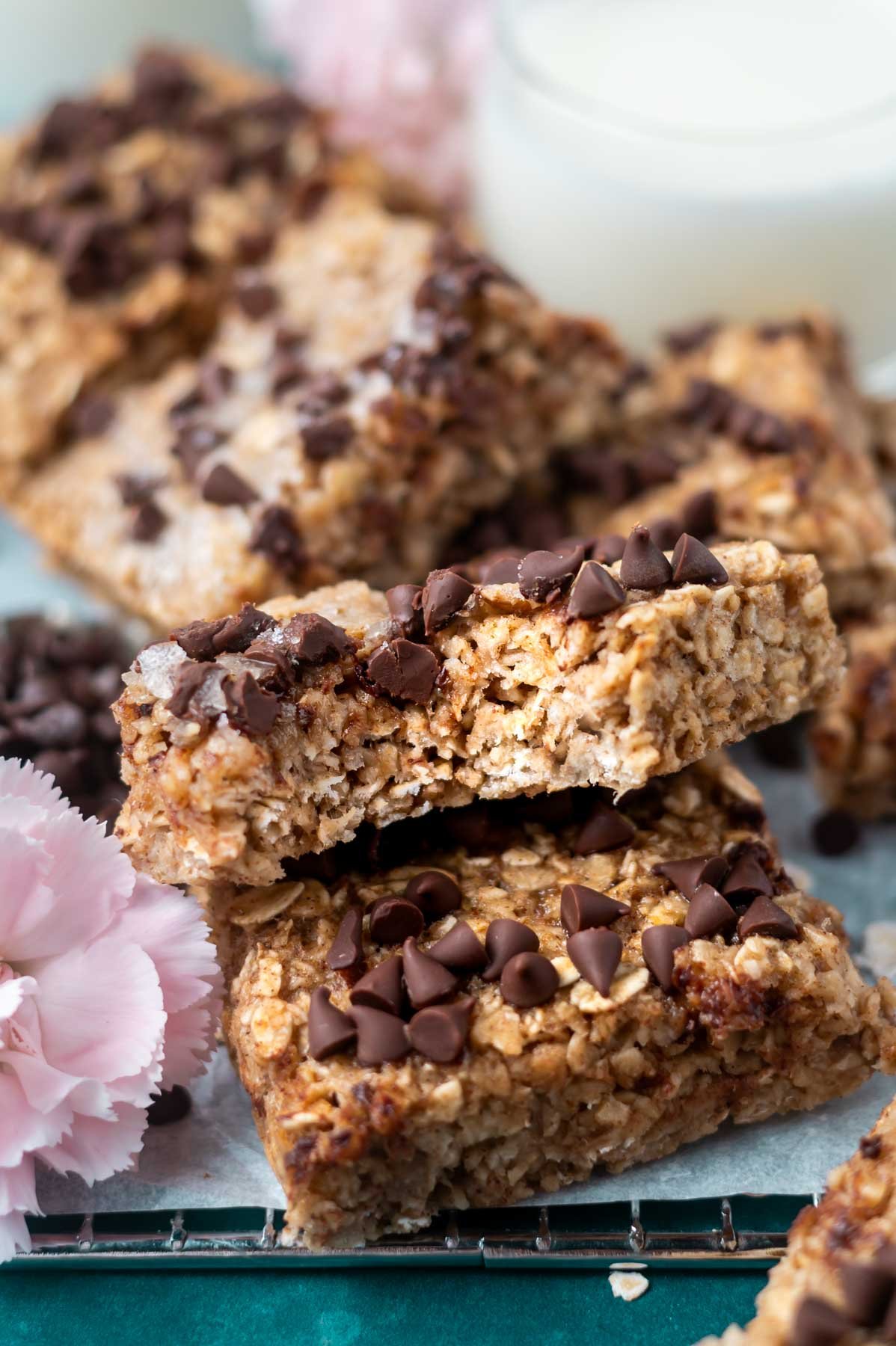breakfast bar with a bite missing leaning against another bar with milk in the background