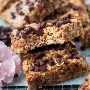 breakfast bar with a bite missing leaning against another bar with milk in the background