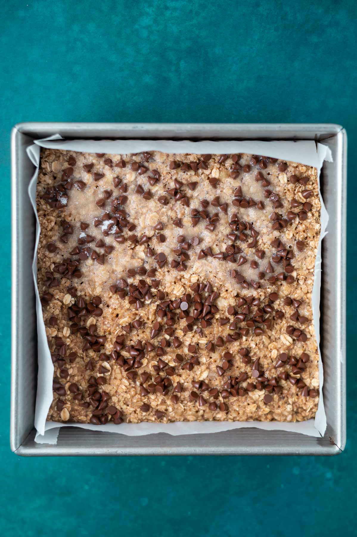 baked banana breakfast cake in a parchment lined baking pan