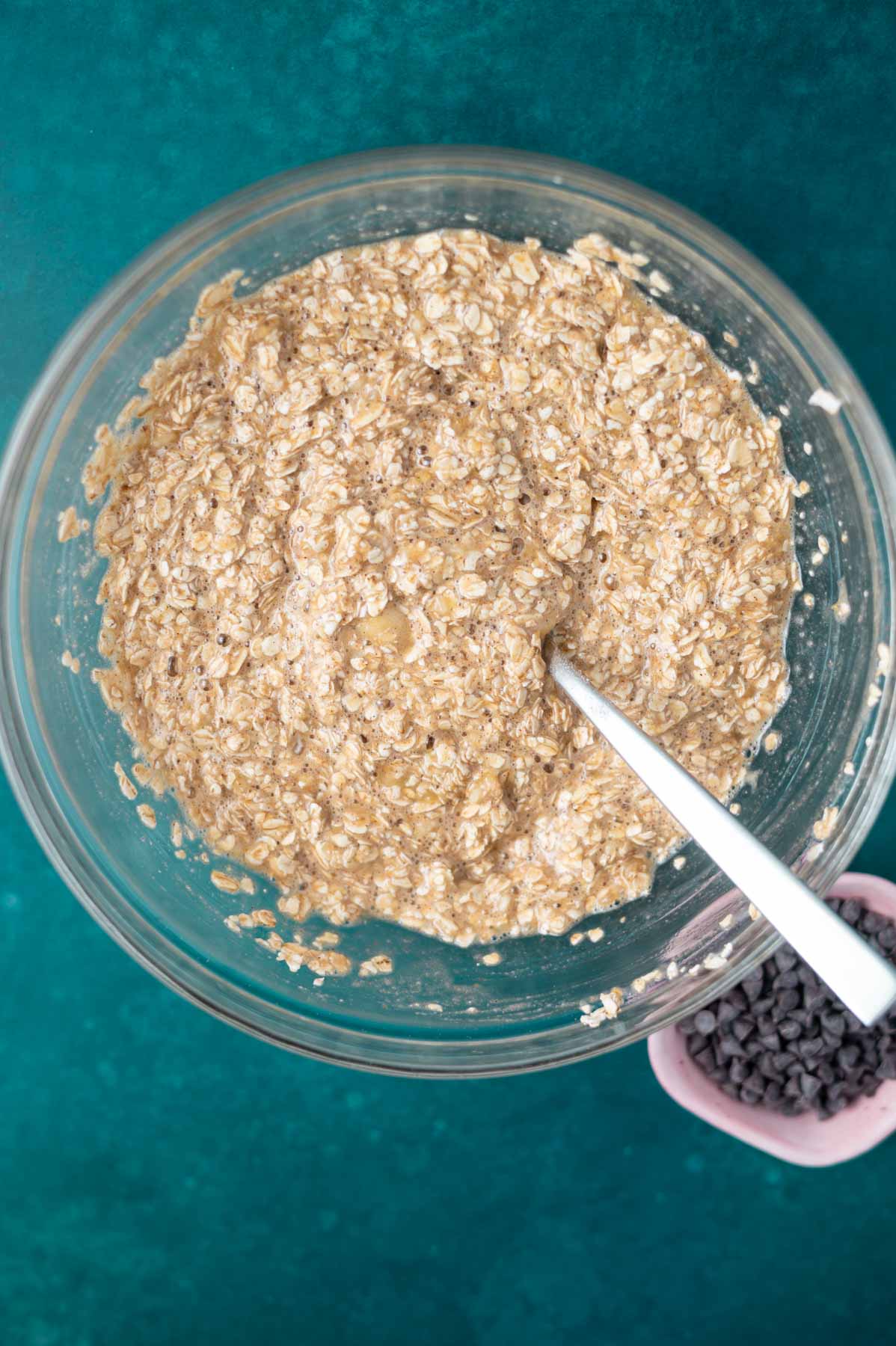 old fashioned and quick oats added to mashed bananas in a mixing bowl