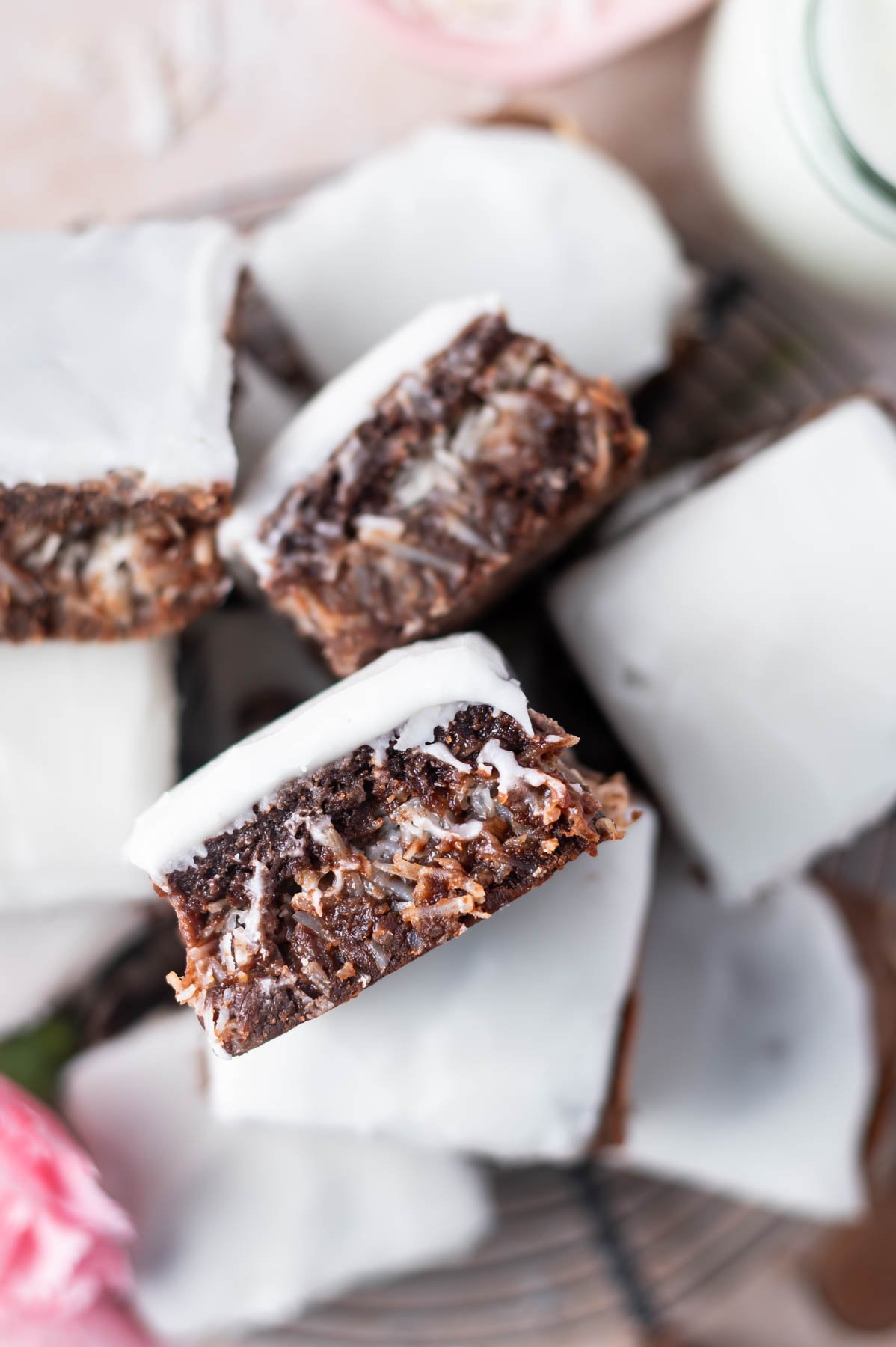 pile coconut brownies with one showing coconut stuffed middle