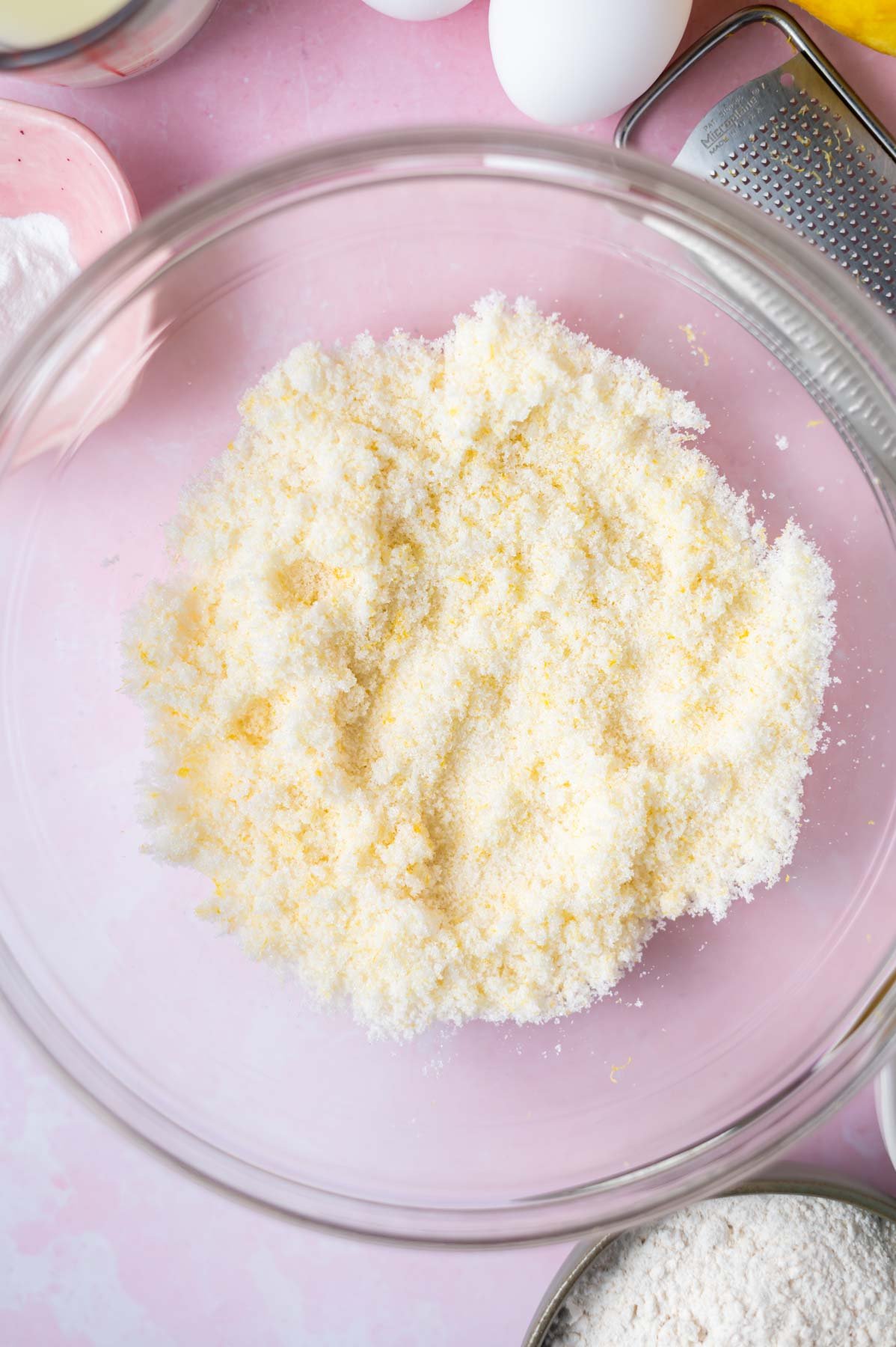 lemon zest worked into sugar in a glass bowl