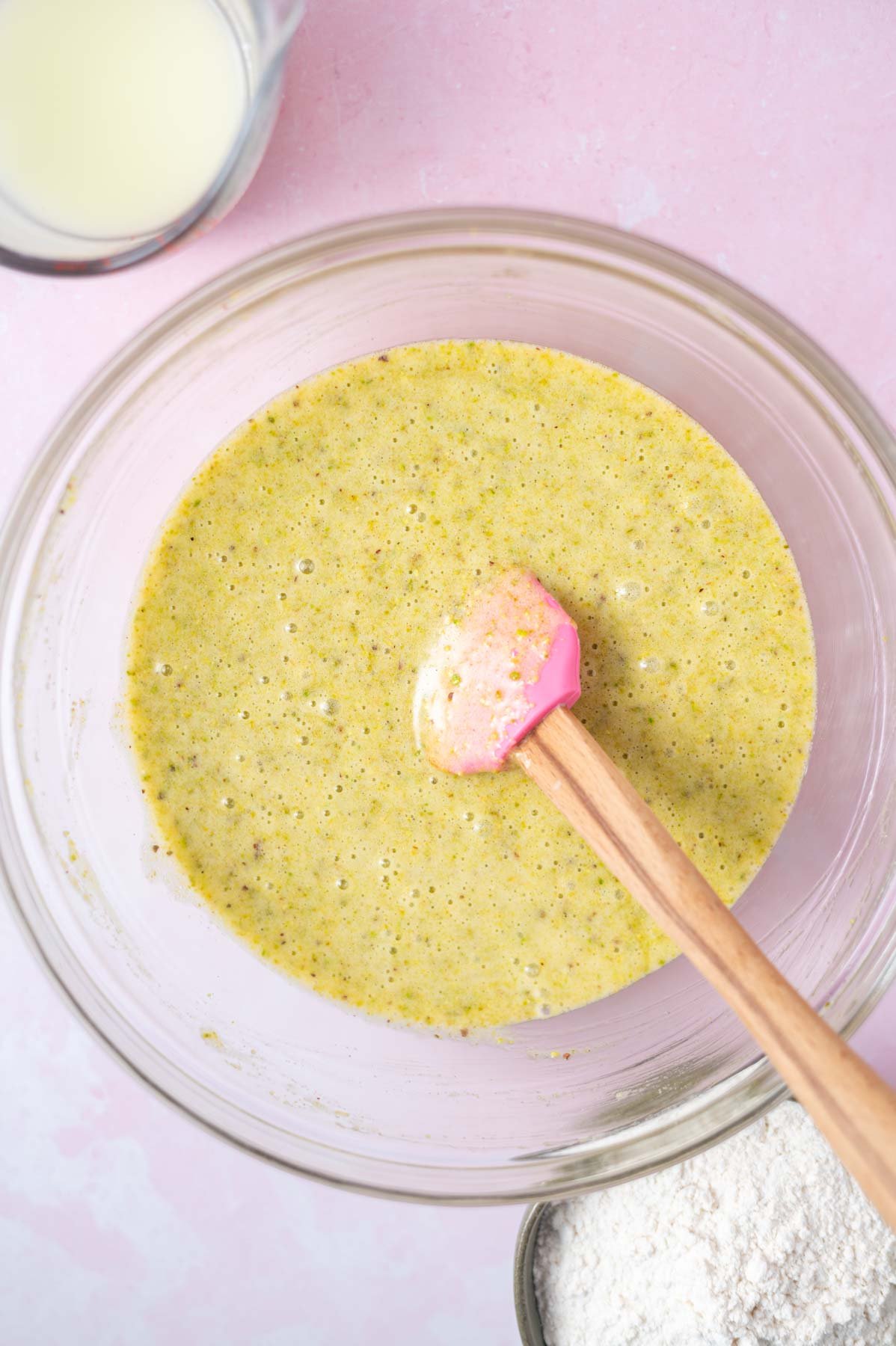 cake batter in a bowl with a spatula before milk and flour are added