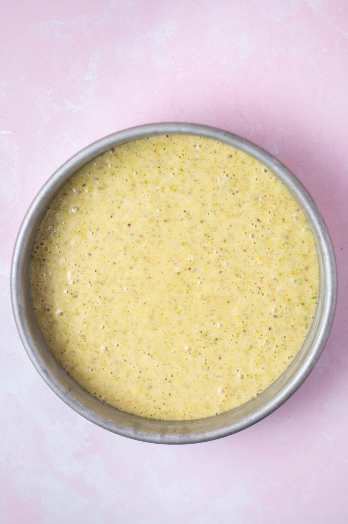 cake batter in a round cake pan