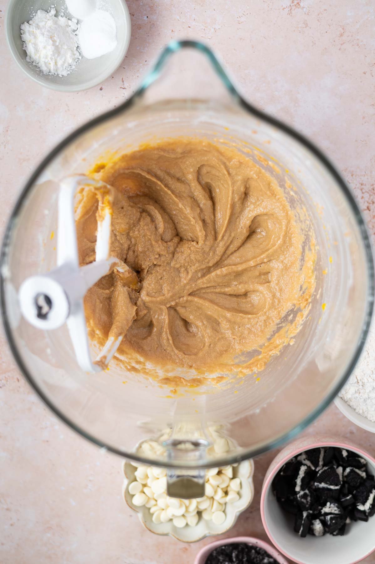 butter, sugars, salt and eggs mixed together in a glass mixing bowl