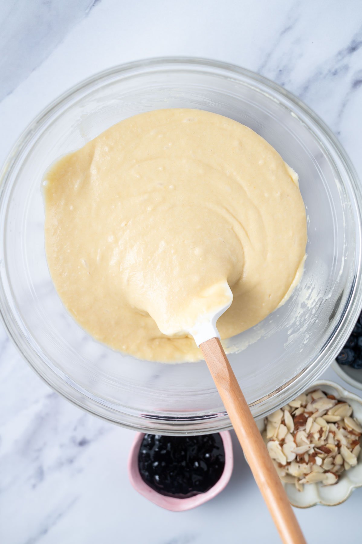 cake batter in a glass bowl with a spatula