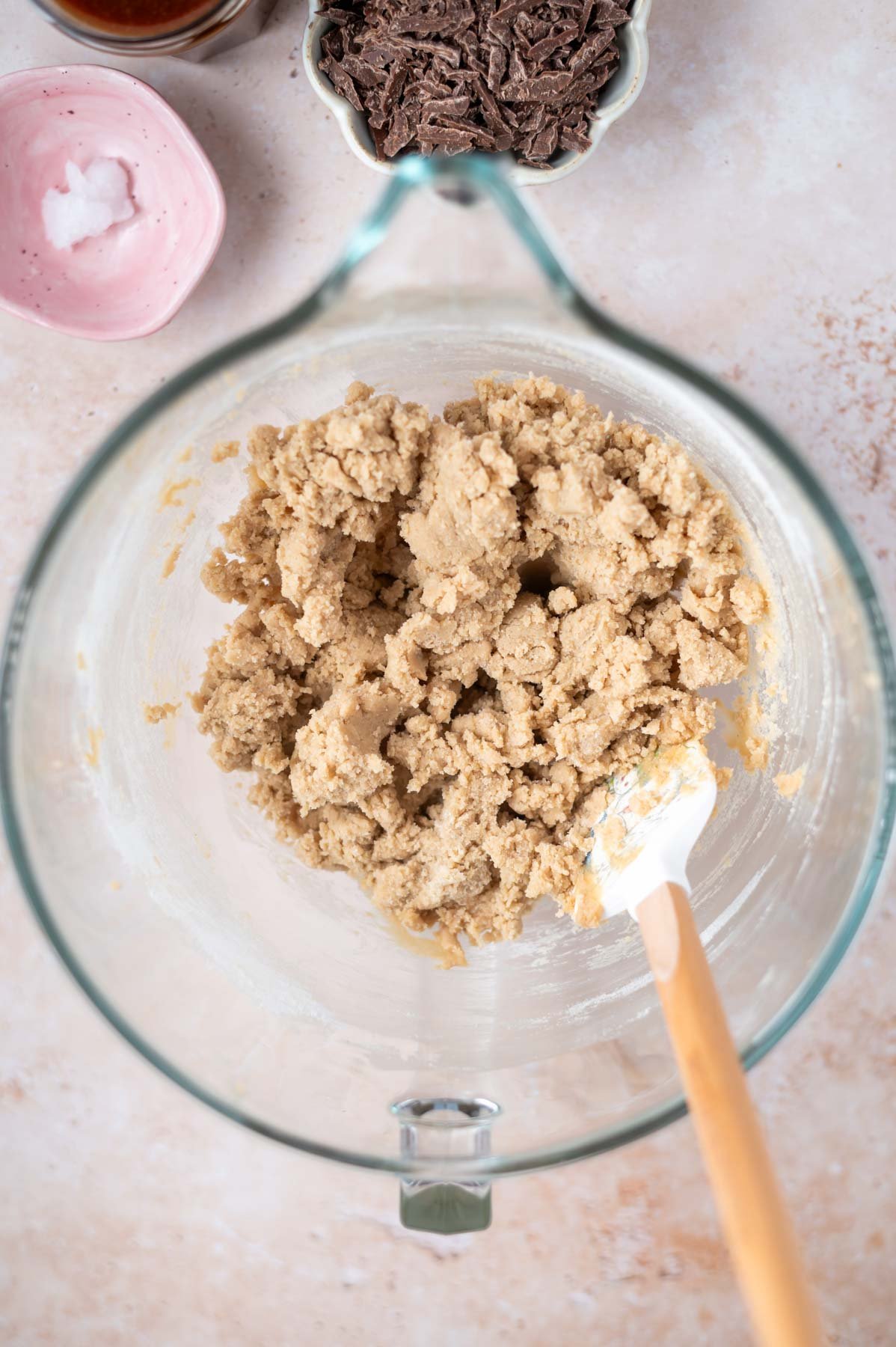 cookie dough in glass mixing bowl with a spatula