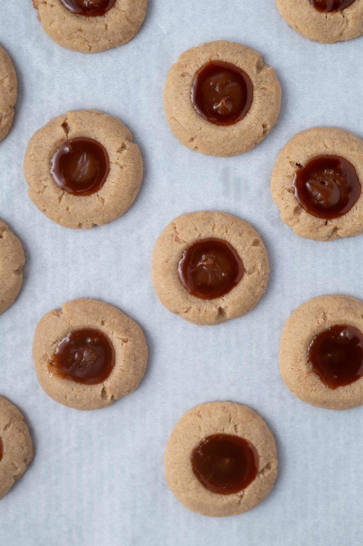 caramel sauce added to thumbprint cookies after baking