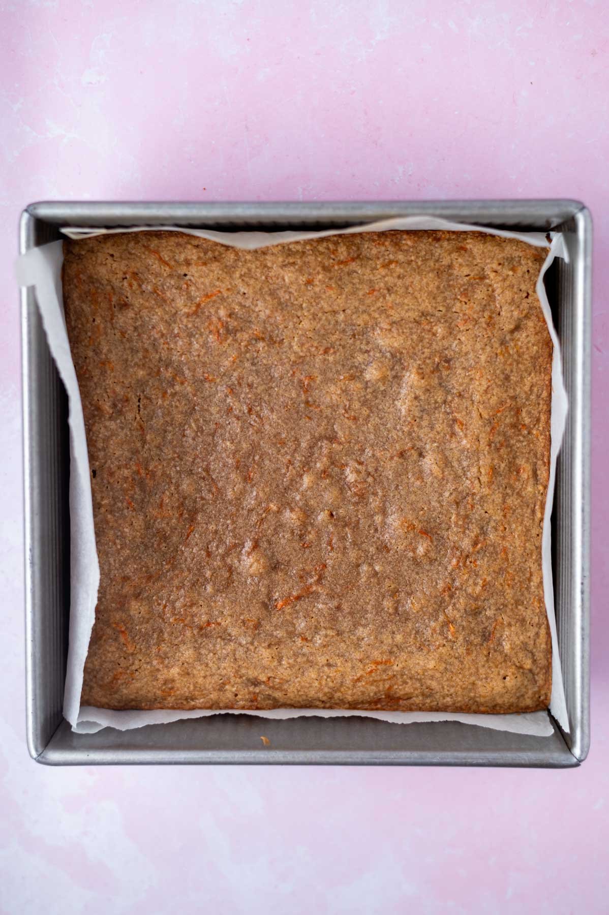 baked blondies in a parchment lined 8x8 pan