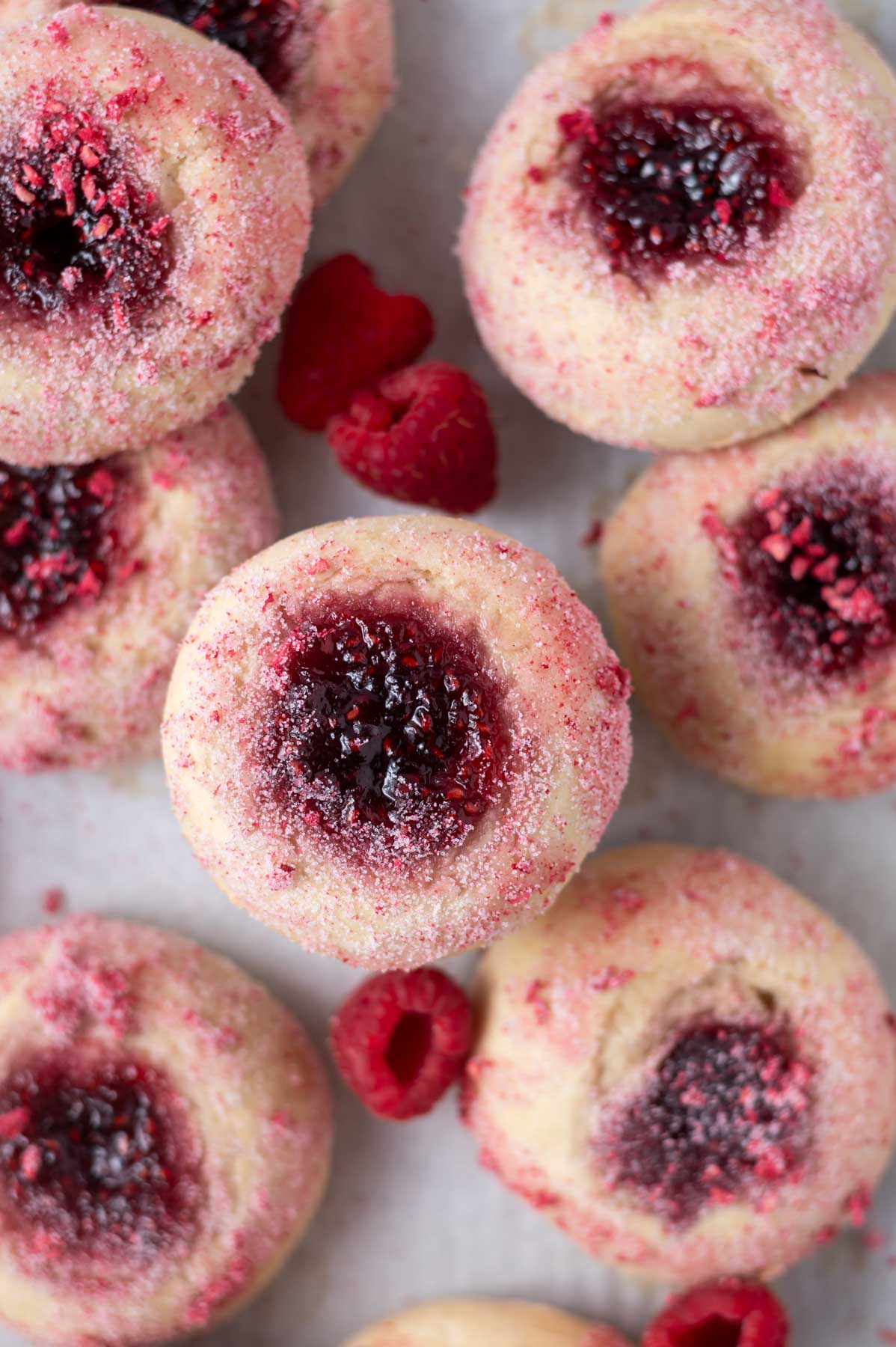 overhead look at jam filled donuts with fresh raspberries
