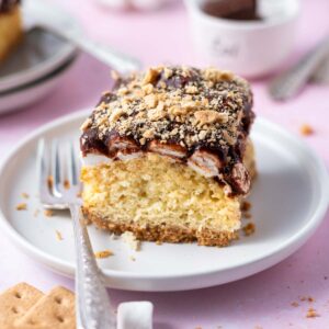 slice of s'mores cake on a plate with a fork