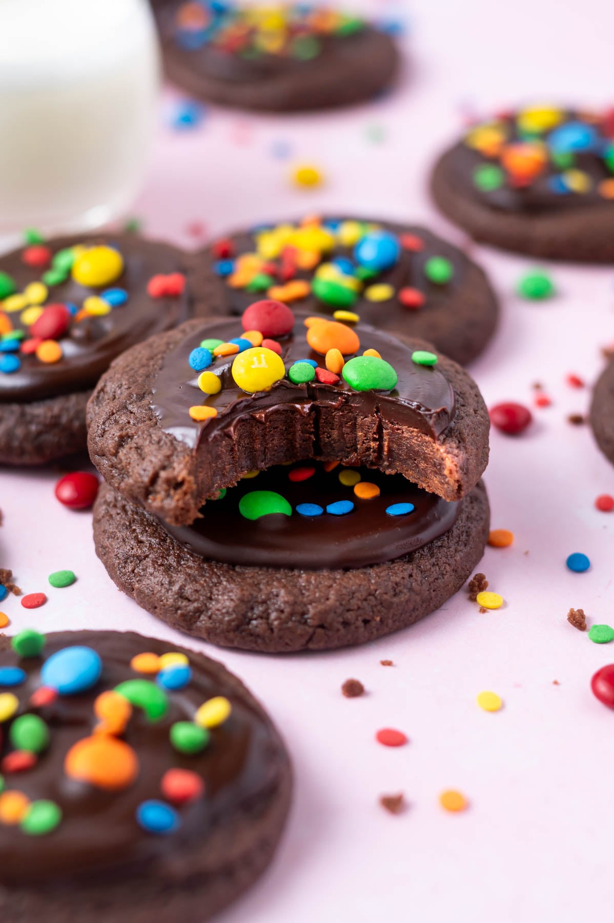 stack of cosmic brownie cookies with the top one missing a bite